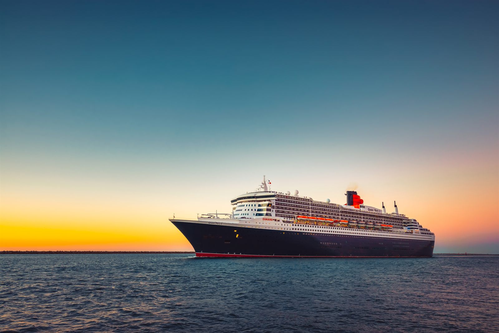 Ocean liner sailing on a calm sea at sunset
