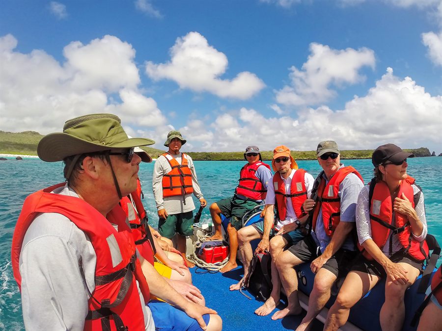 Travelers wearing life jackets on a boat